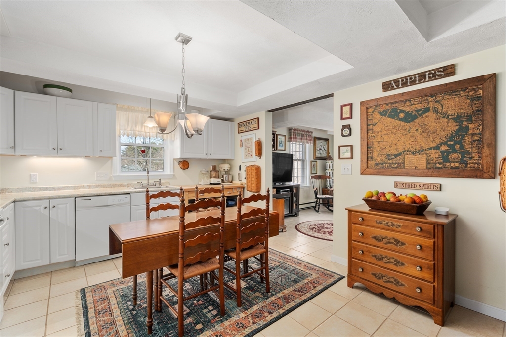 4 Greybirch Road Andover, MA 01810 - Photo 31 of 42 a kitchen with stainless steel appliances kitchen island granite countertop a table and chairs in it