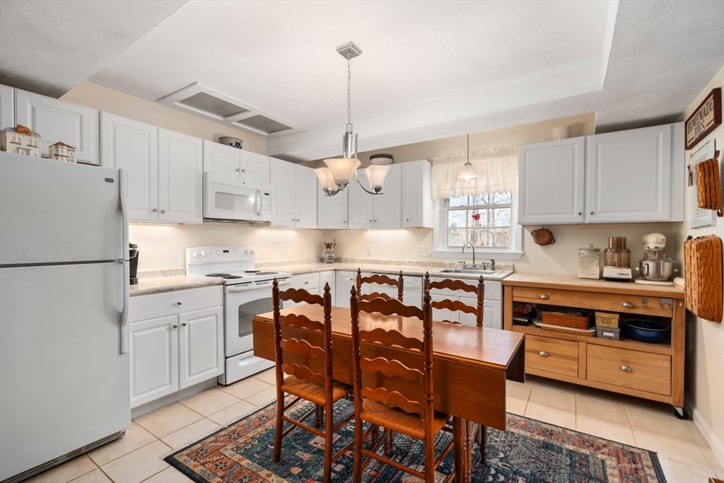 4 Greybirch Road Andover, MA 01810 - Photo 32 of 42 a kitchen with stainless steel appliances granite countertop a white cabinets and wooden floor