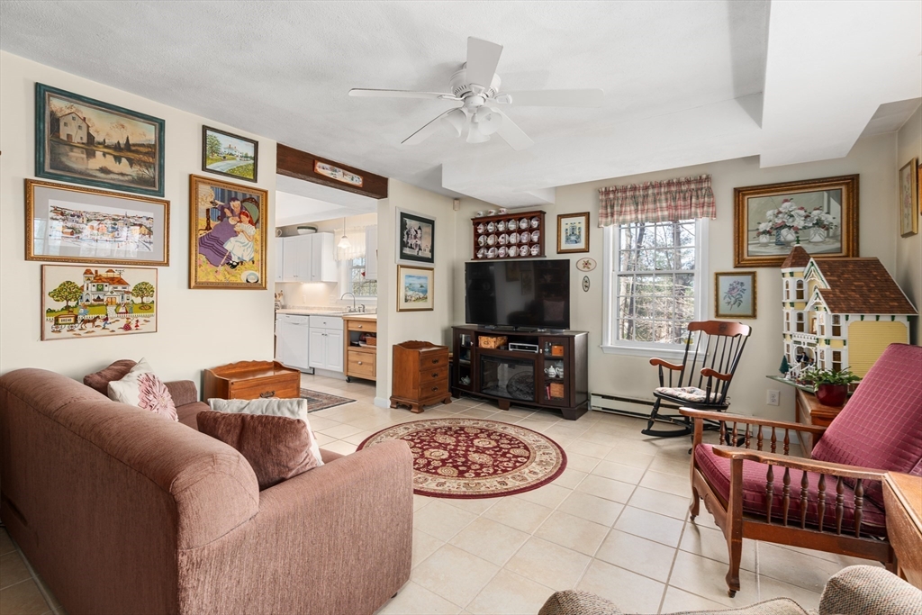 4 Greybirch Road Andover, MA 01810 - Photo 36 of 42 a living room with furniture a flat screen tv and a window