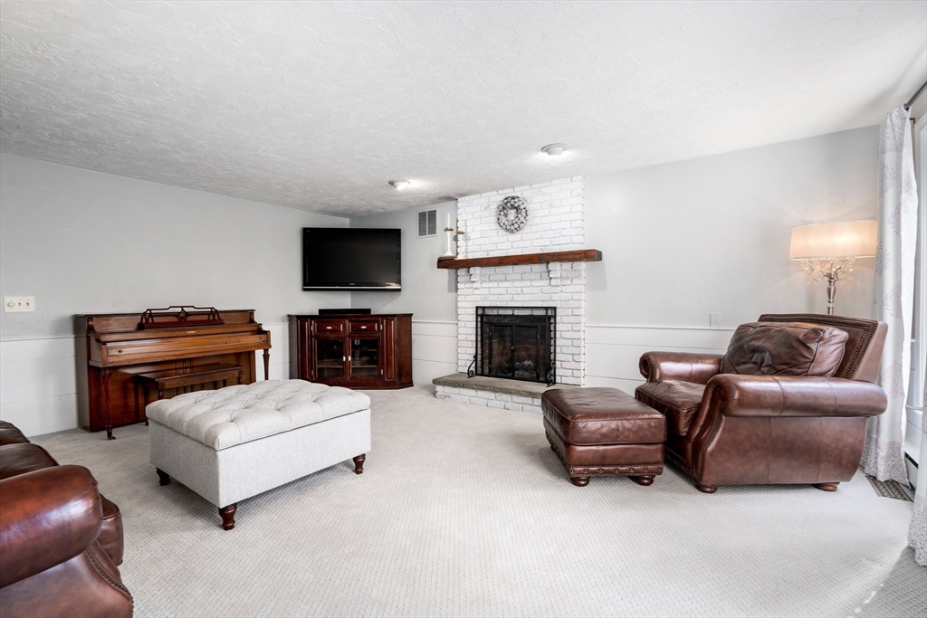 4 Greybirch Road Andover, MA 01810 - Photo 4 of 42 a living room with furniture and a fireplace