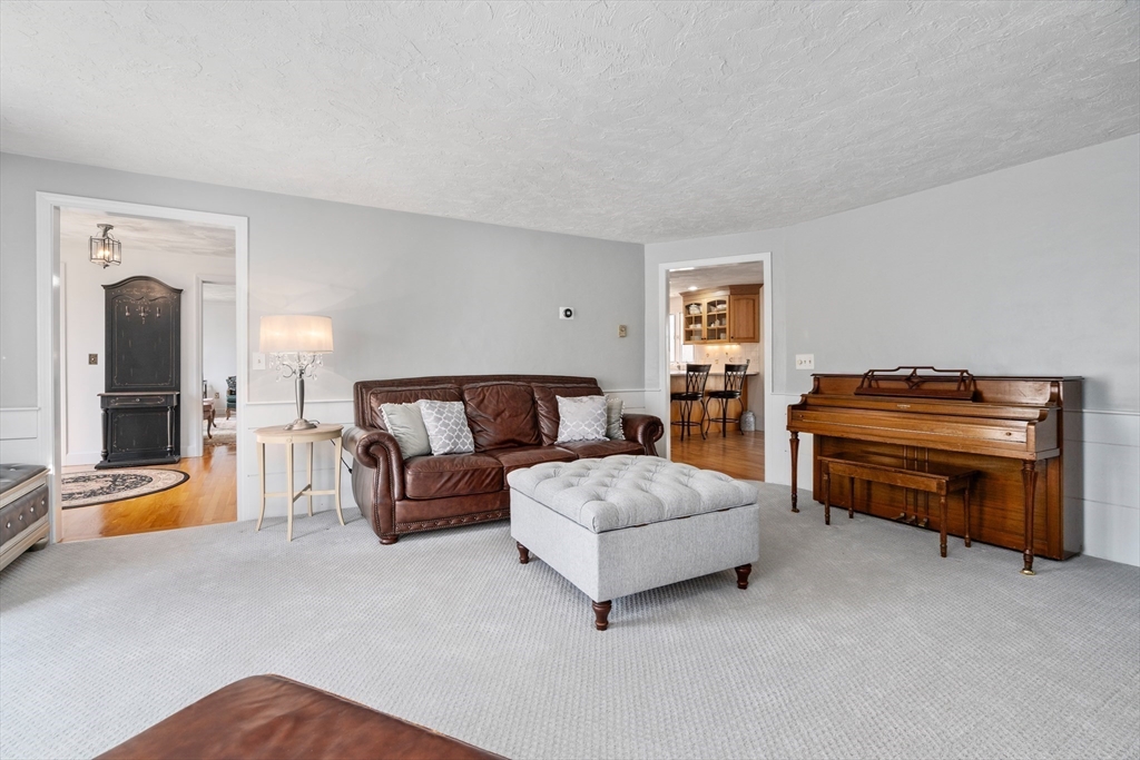 4 Greybirch Road Andover, MA 01810 - Photo 6 of 42 a spacious bedroom with a bed and a chandelier