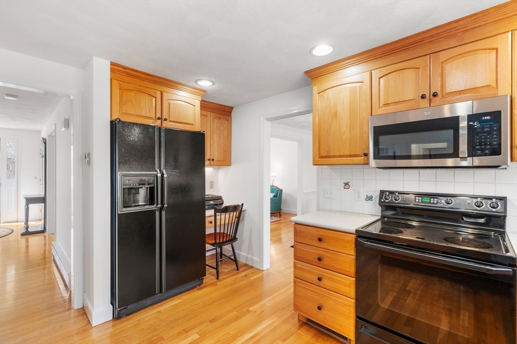 4 Greybirch Road Andover, MA 01810 - Photo 9 of 42 a kitchen with stainless steel appliances granite countertop a refrigerator stove and microwave