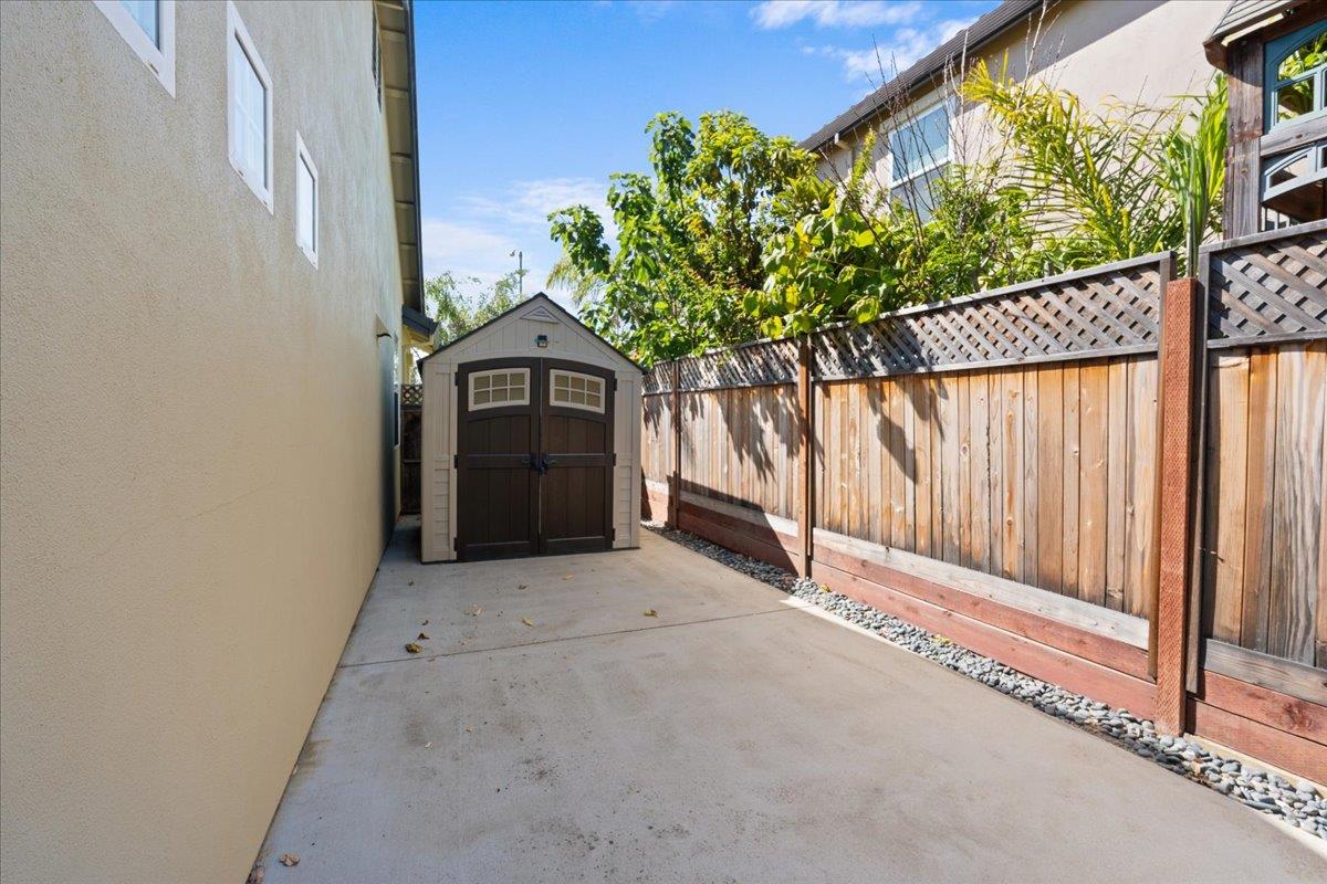 478 Churchill Way Salinas, CA 93906 - Photo 31 of 31 a view of a brick house with a small yard and wooden fence
