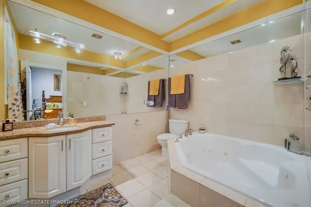 a bathroom with a tub sink and mirror