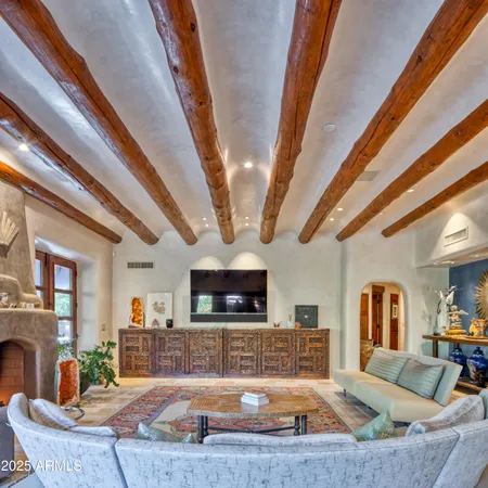 a living room with furniture and a potted plant