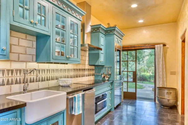 a view of a big house with a big yard and large trees