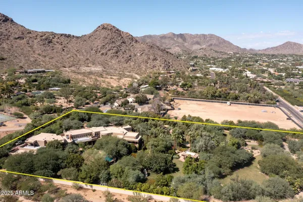 an aerial view of mountain with residential house and green space