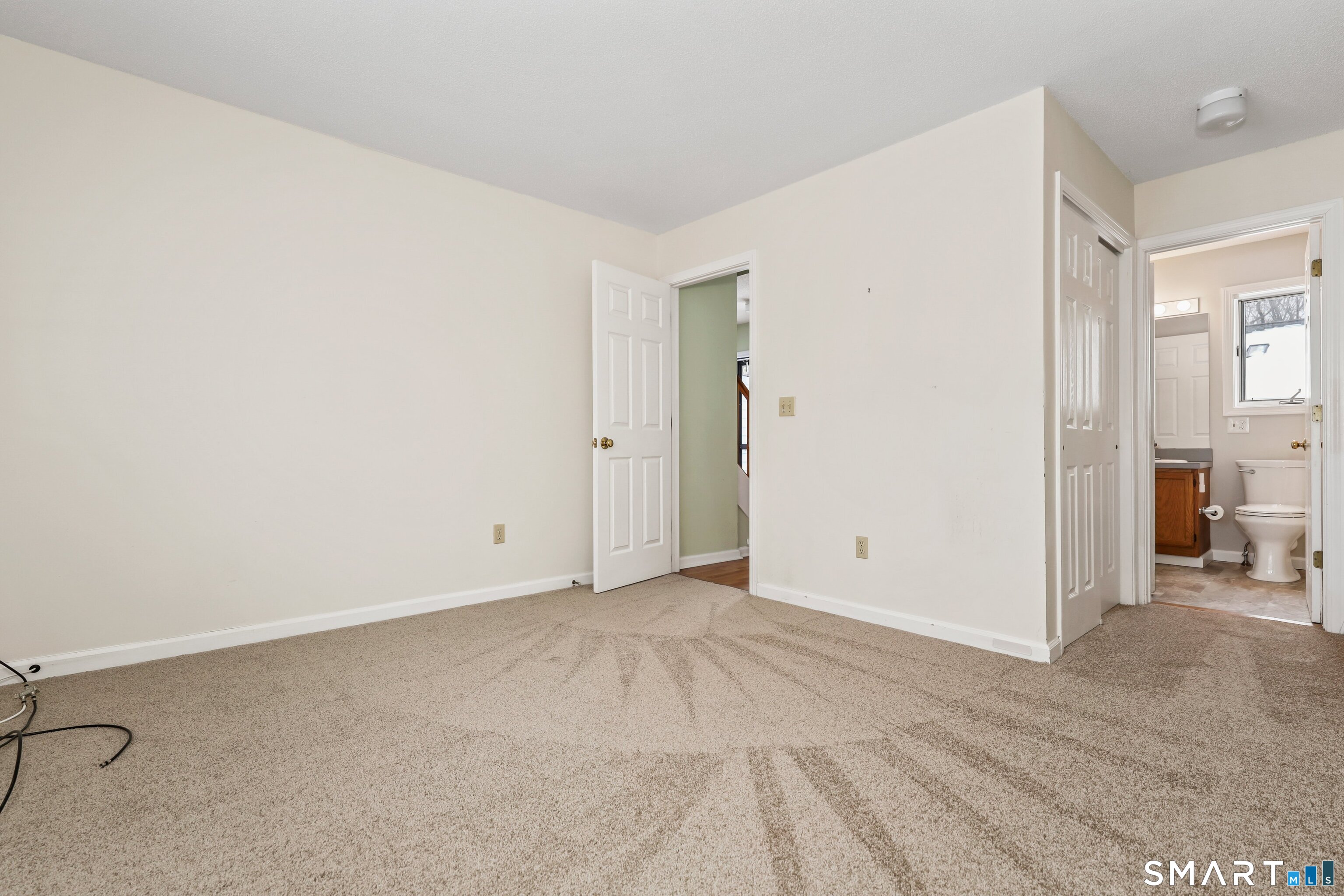 86 Cannon Ridge Drive, Unit 86 Watertown, CT 06795 - Photo 17 of 37 Primary with brand new carpeting and view of the full bathroom