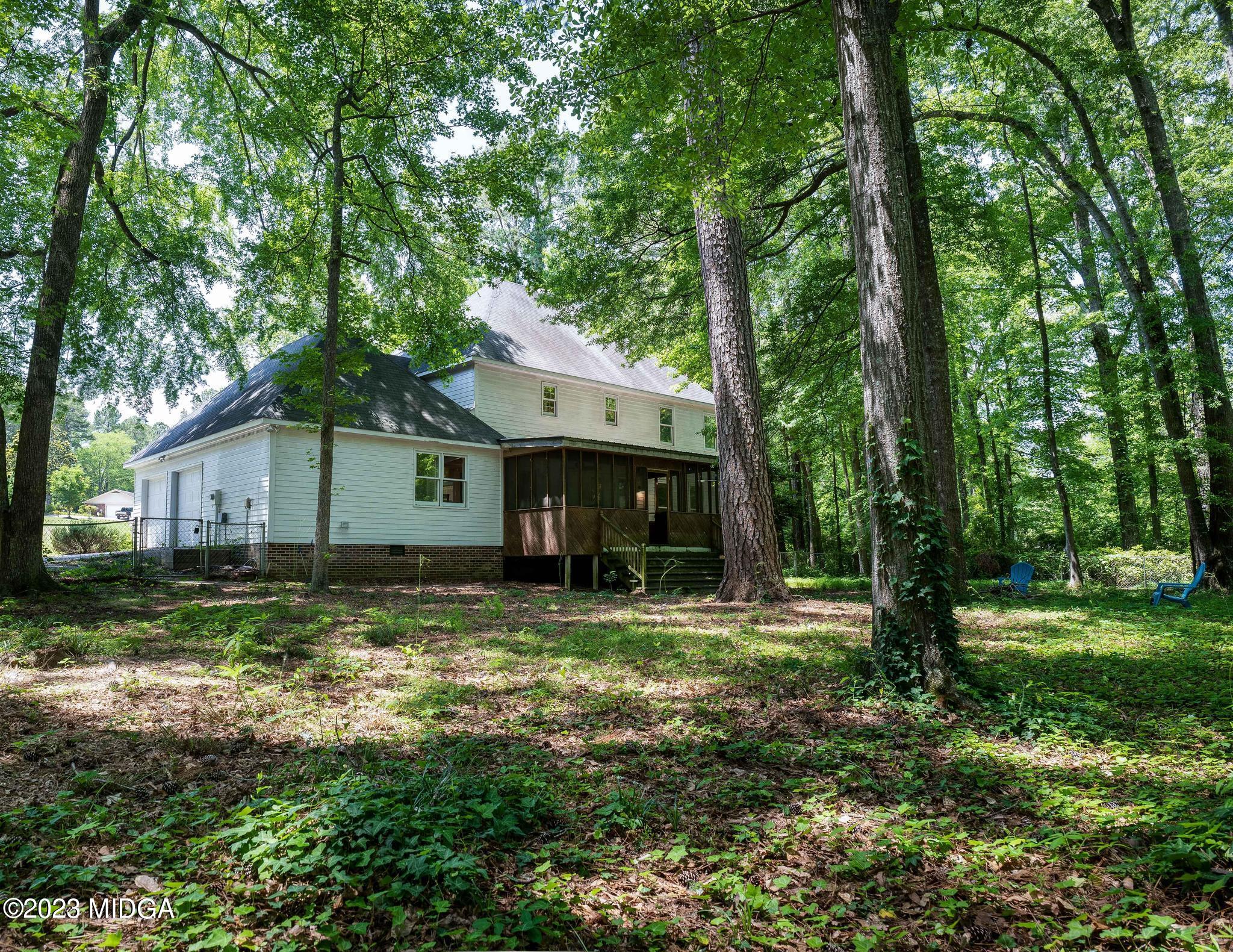 270 Castlegate Road Macon, GA 31210 - Photo 9 of 35 a view of a house with large trees and a big yard