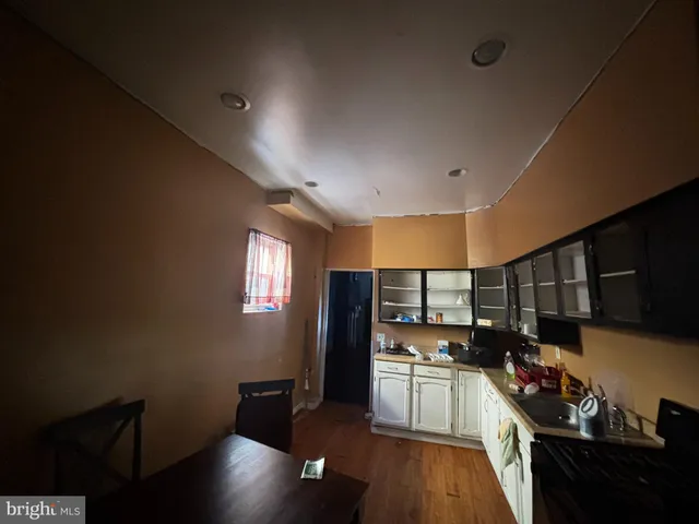 a kitchen with stainless steel appliances stove refrigerator and cabinets