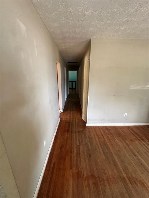 13449 Northeast Jacksonville Road Citra, FL 32113 - Photo 4 of 6 a view of a hallway with wooden floor
