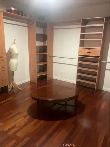 a room with wooden floor and furniture