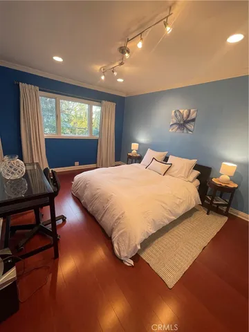 a bedroom with a bed window and dresser