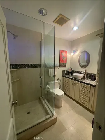 a bathroom with a shower sink vanity and mirror