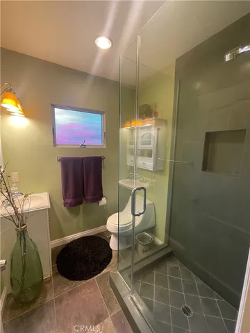 a bathroom with a toilet a sink and shower