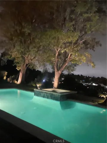 a view of a field of grass and trees