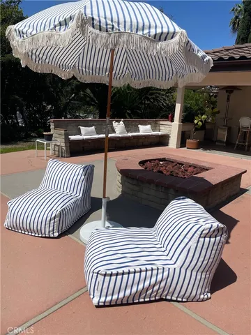 a view of a patio with a table and chairs and potted plants