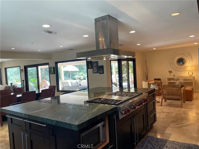 a kitchen with stainless steel appliances granite countertop a stove a sink and a refrigerator