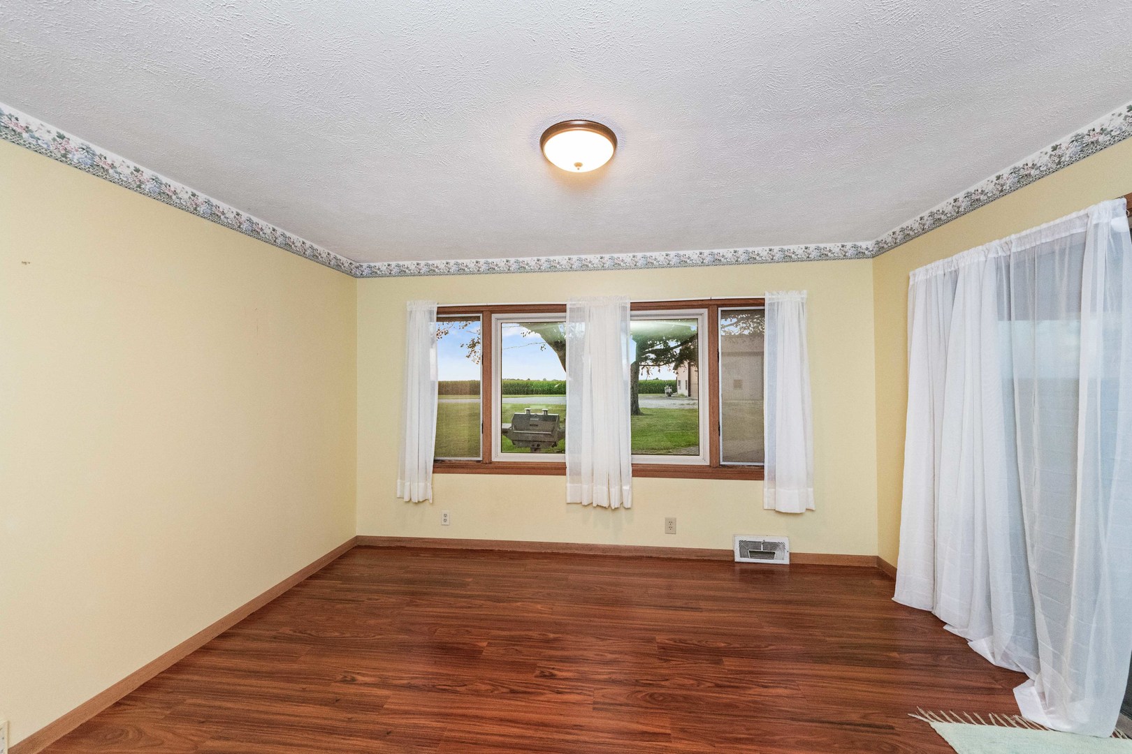 947 North 2nd Road Dana, IL 61321 - Photo 21 of 35 a view of an empty room with wooden floor and a window