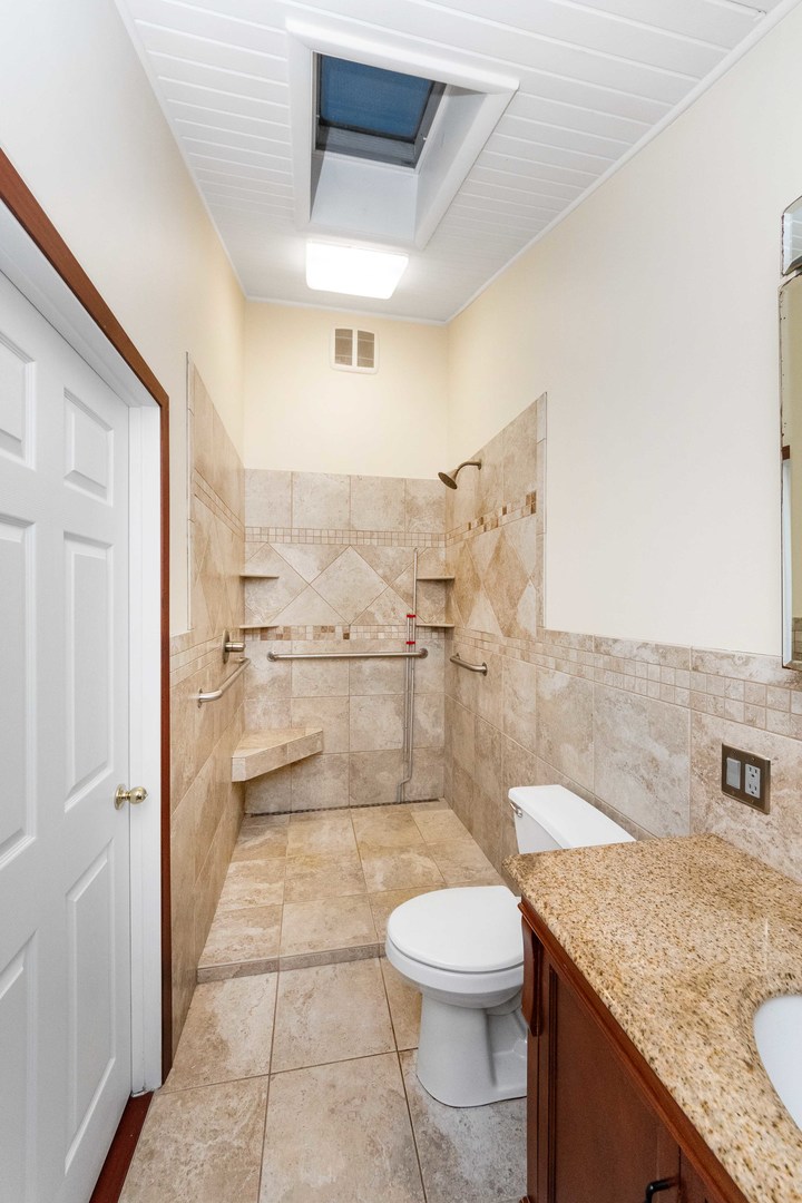 947 North 2nd Road Dana, IL 61321 - Photo 22 of 35 a bathroom with a granite countertop sink a toilet a mirror and bathtub