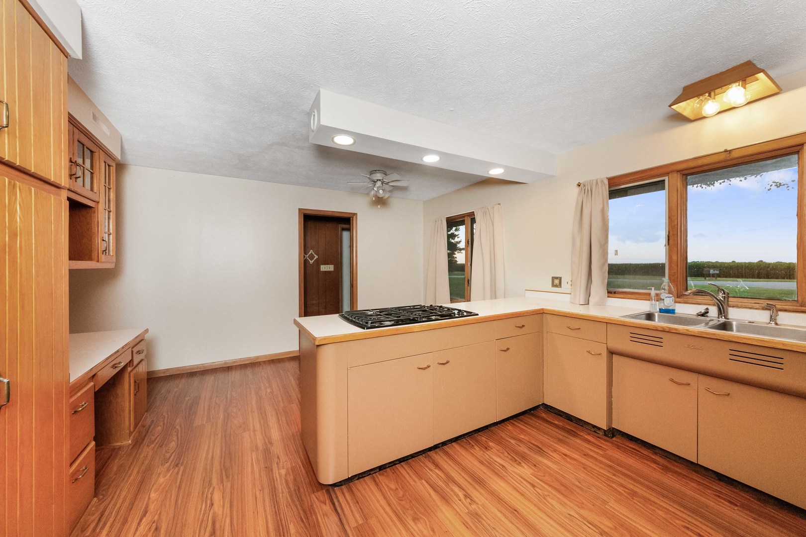 947 North 2nd Road Dana, IL 61321 - Photo 4 of 35 a large kitchen with a wooden floor and cabinets