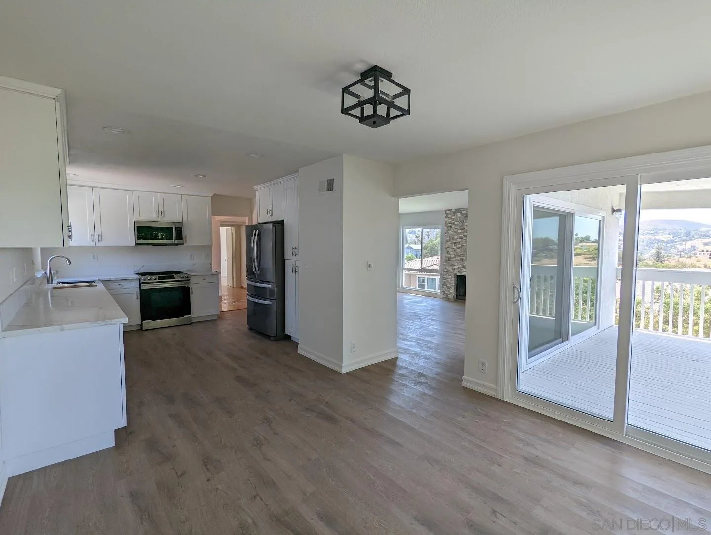 9347 Kahlua Way Spring Valley, CA 91977 - Photo 13 of 67 a view of a kitchen with a sink dishwasher cabinets and a kitchen