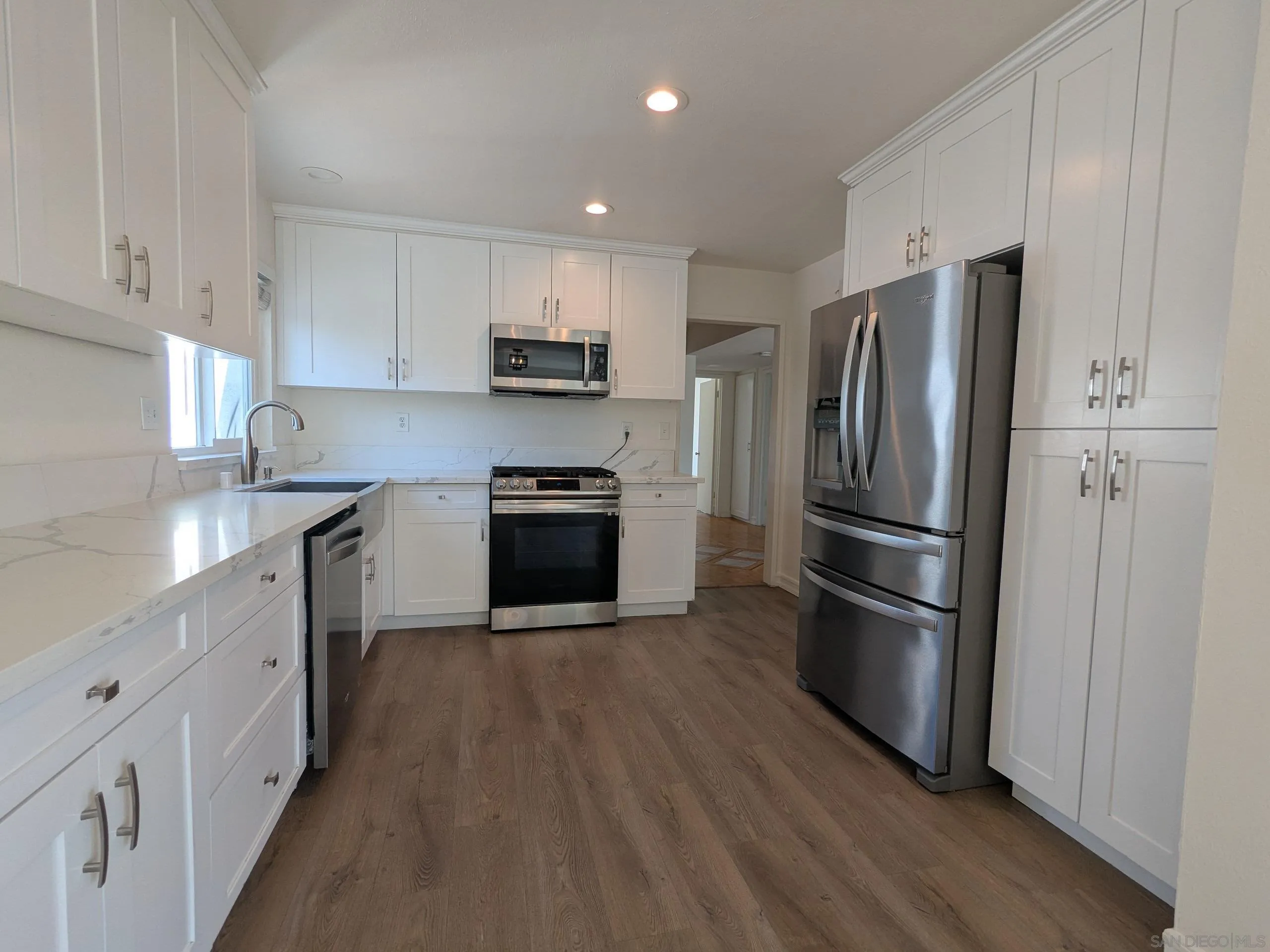 9347 Kahlua Way Spring Valley, CA 91977 - Photo 16 of 67 a kitchen with stainless steel appliances a refrigerator sink and cabinets