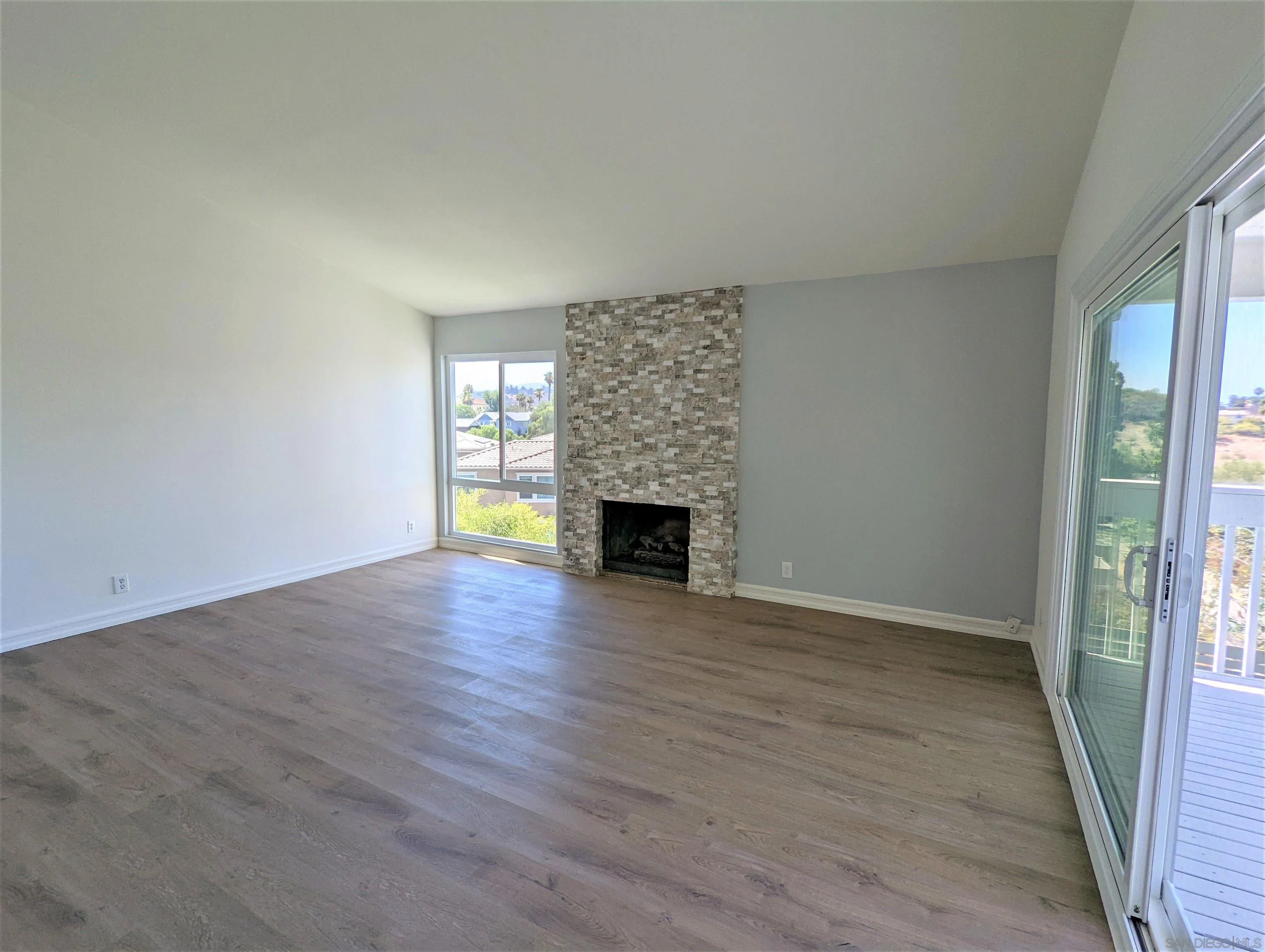 9347 Kahlua Way Spring Valley, CA 91977 - Photo 19 of 67 a view of an empty room with wooden floor and a window