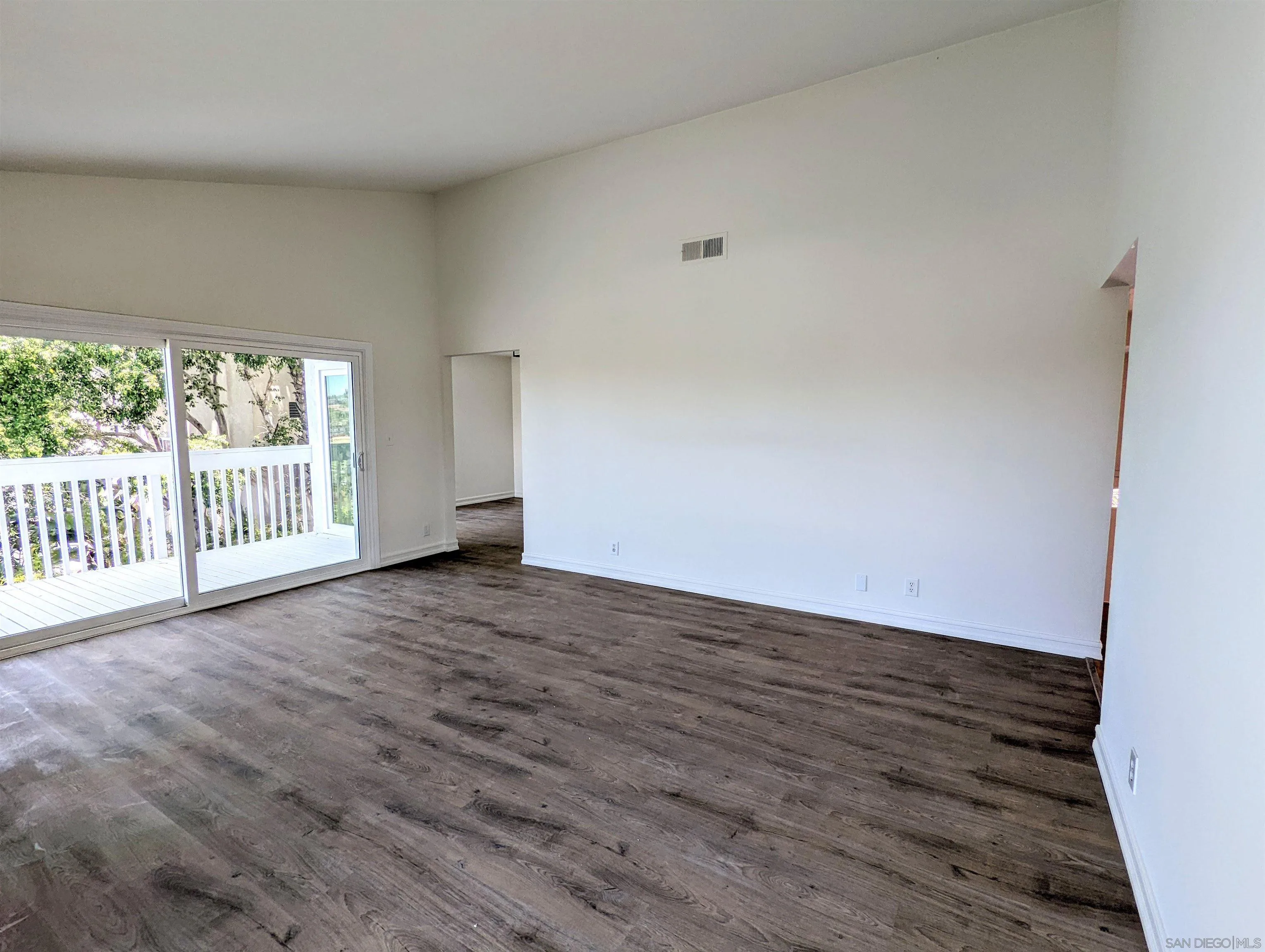 9347 Kahlua Way Spring Valley, CA 91977 - Photo 20 of 67 a view of an empty room with wooden floor and a window