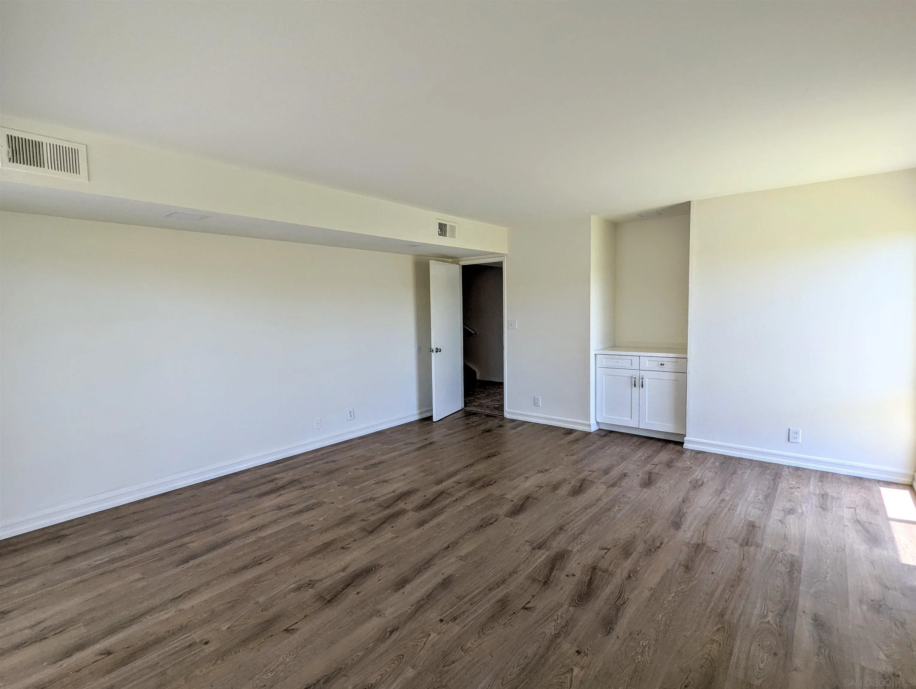 9347 Kahlua Way Spring Valley, CA 91977 - Photo 23 of 67 a view of an empty room with wooden floor and closet