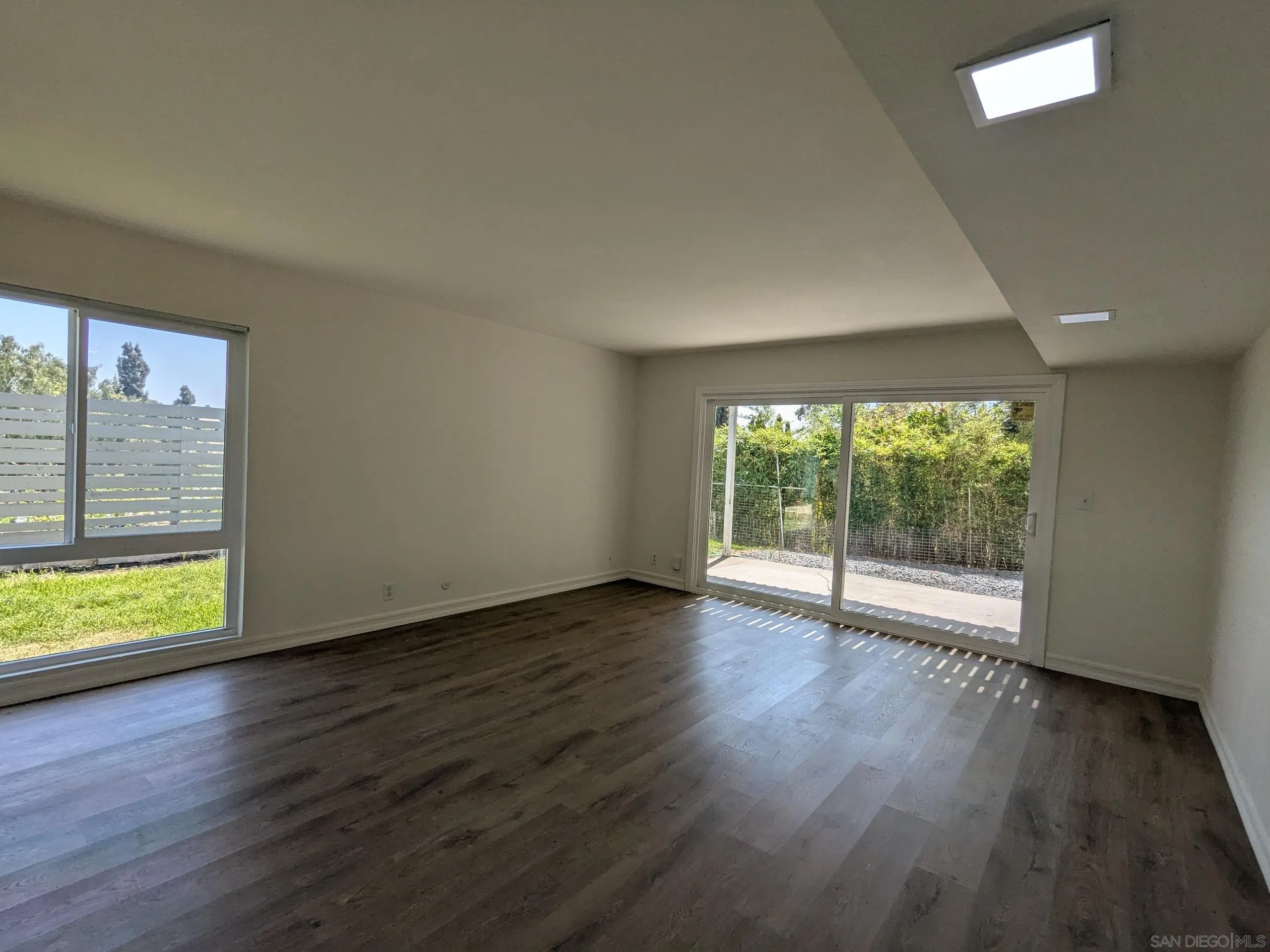 9347 Kahlua Way Spring Valley, CA 91977 - Photo 24 of 67 a view of an empty room with wooden floor and a window