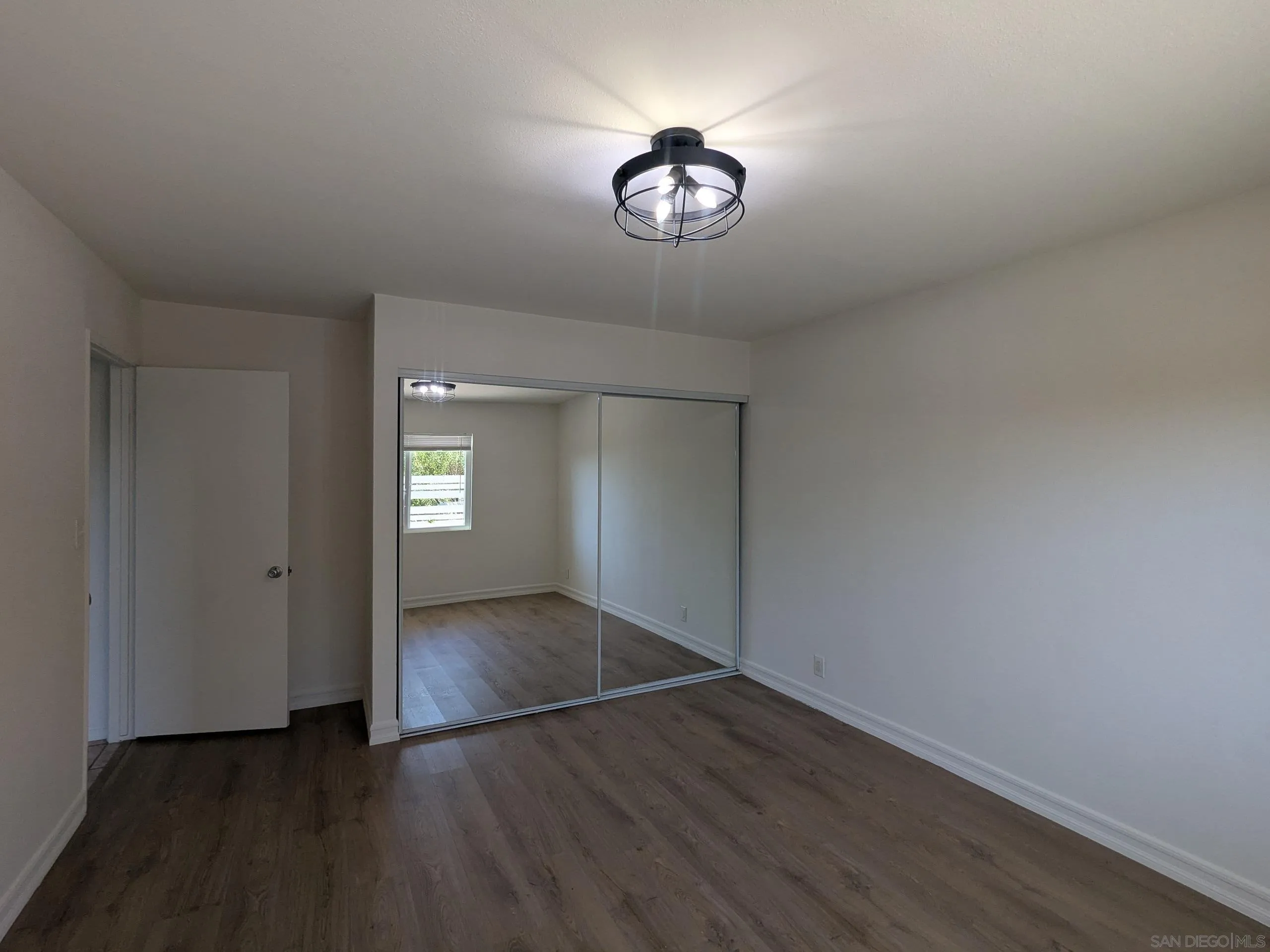 9347 Kahlua Way Spring Valley, CA 91977 - Photo 30 of 67 an empty room with wooden floor and windows