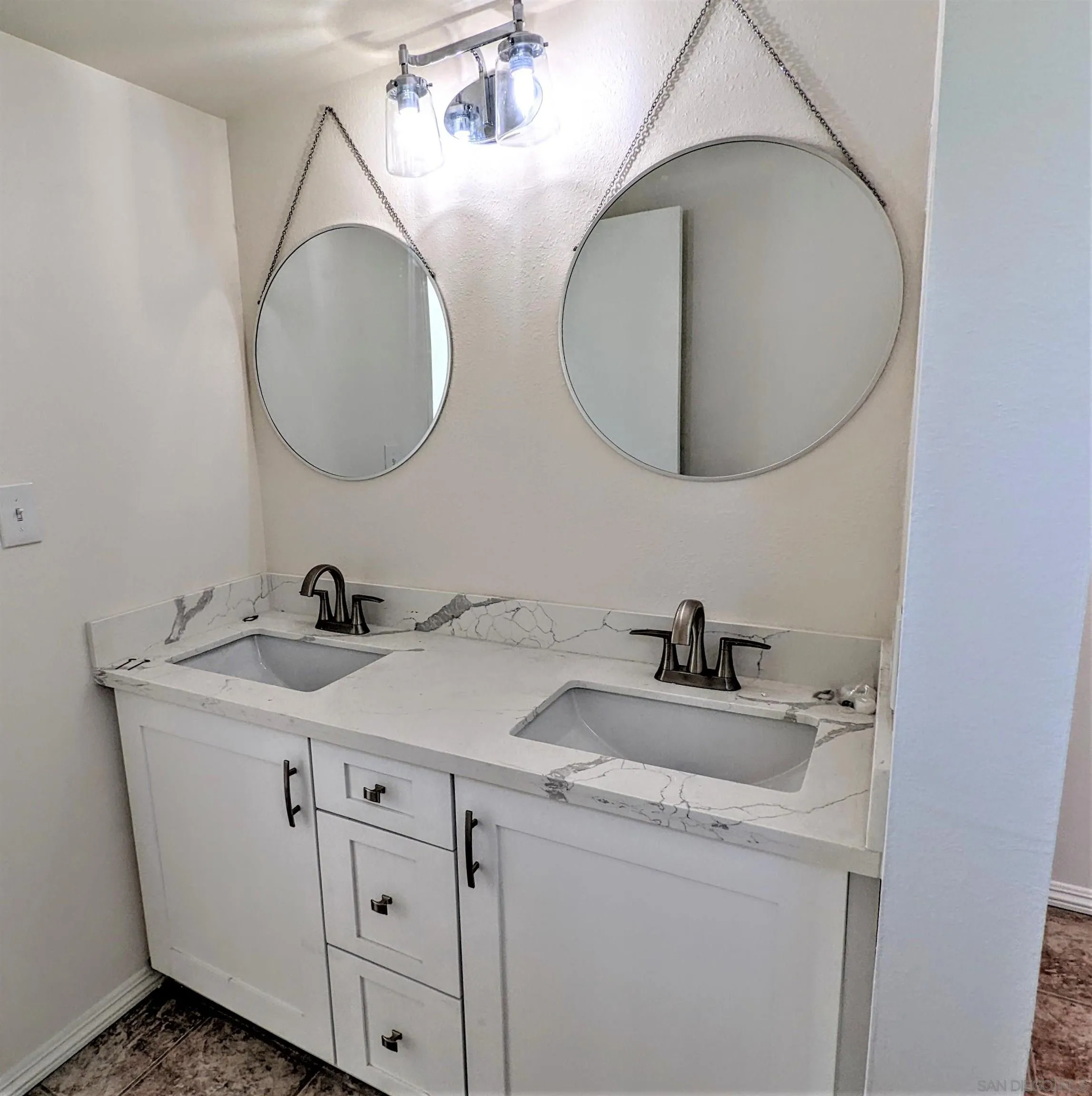 9347 Kahlua Way Spring Valley, CA 91977 - Photo 31 of 67 a bathroom with a sink and a mirror