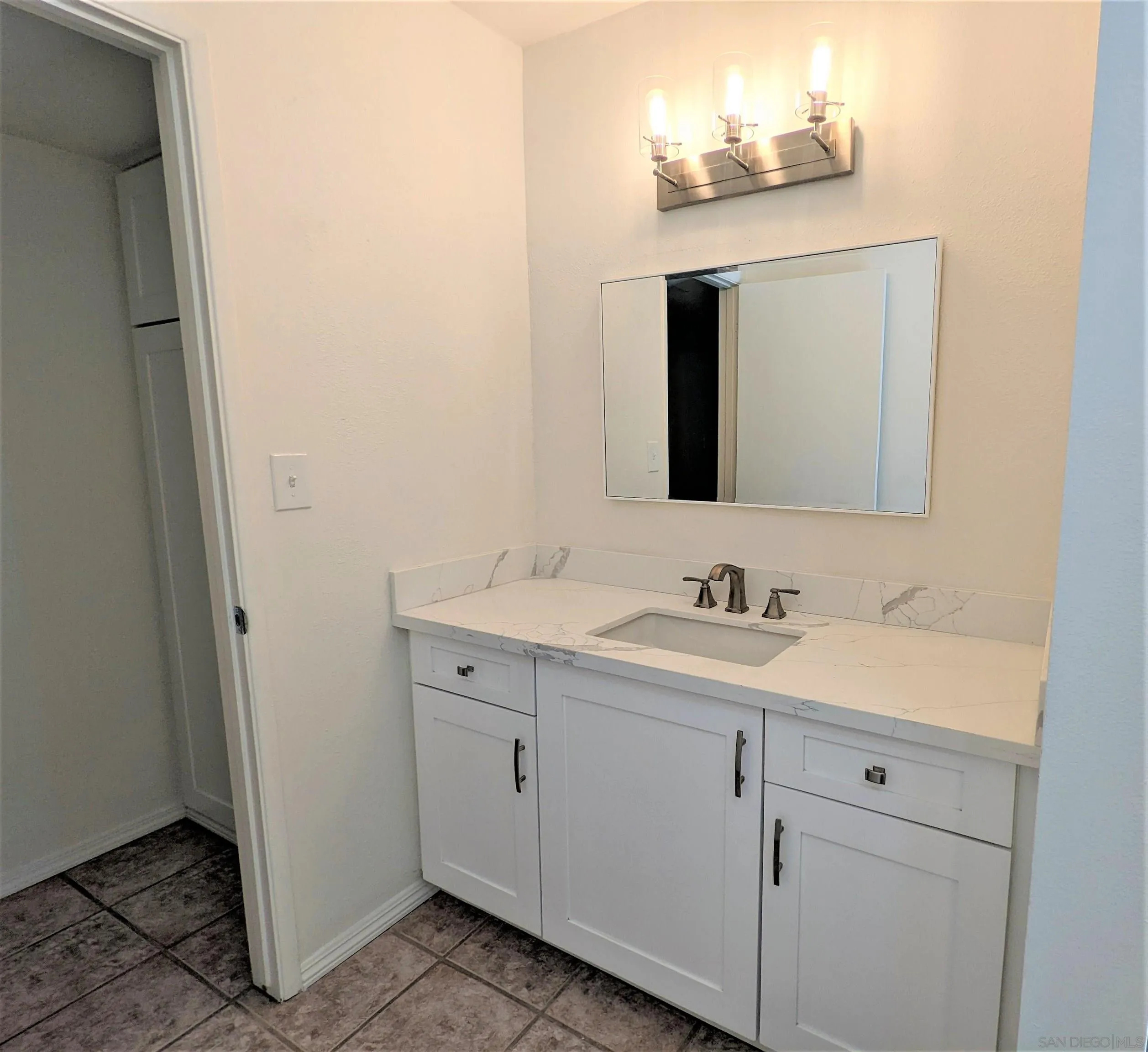 9347 Kahlua Way Spring Valley, CA 91977 - Photo 32 of 67 a bathroom with a sink and a mirror