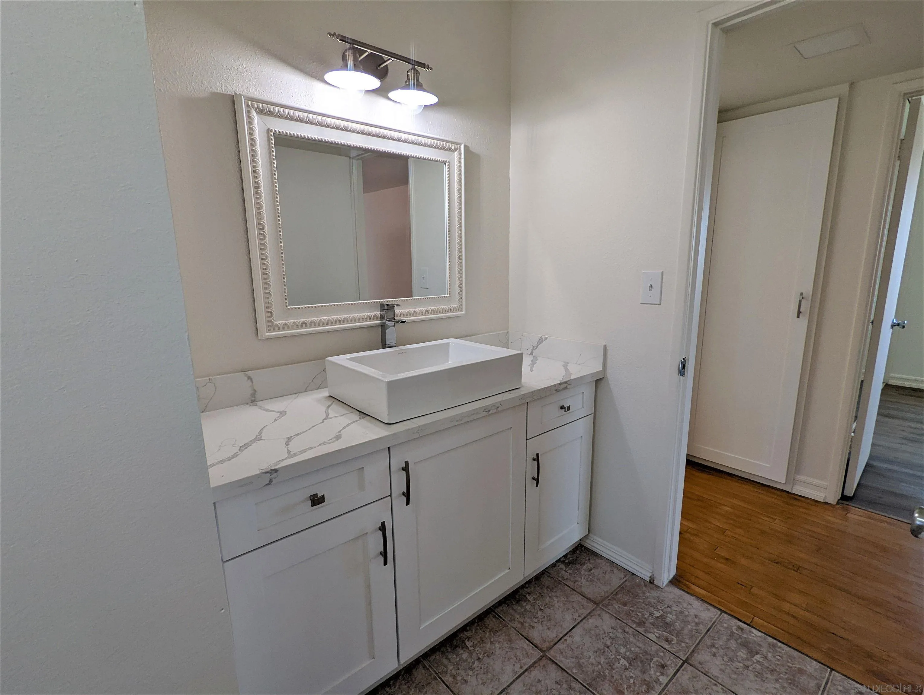 9347 Kahlua Way Spring Valley, CA 91977 - Photo 33 of 67 a bathroom with a sink and a mirror