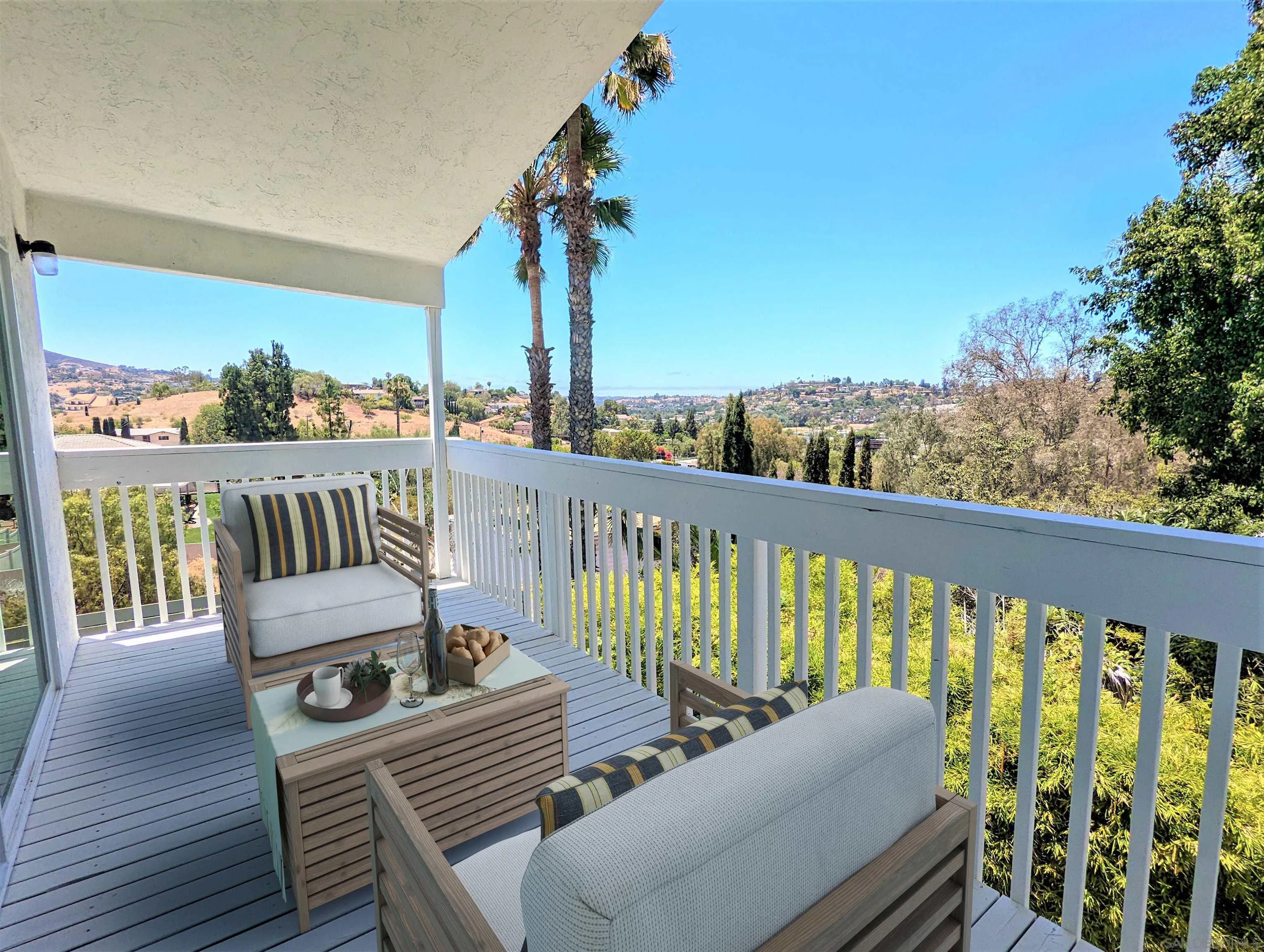 9347 Kahlua Way Spring Valley, CA 91977 - Photo 4 of 67 a view of a balcony with chairs and wooden floor