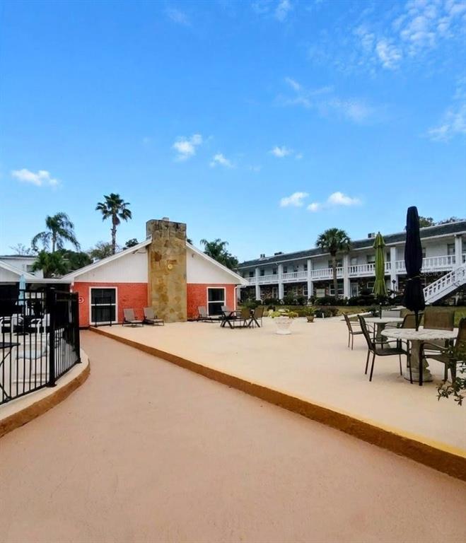 4744 Azalea Drive, Unit 204 New Port Richey, FL 34652 - Photo 18 of 20 a view of a house with swimming pool and sitting area