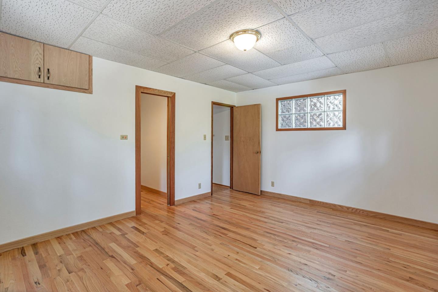 22178 Miller Ridge Road Los Gatos, CA 95033 - Photo 14 of 33 an empty room with wooden floor and windows