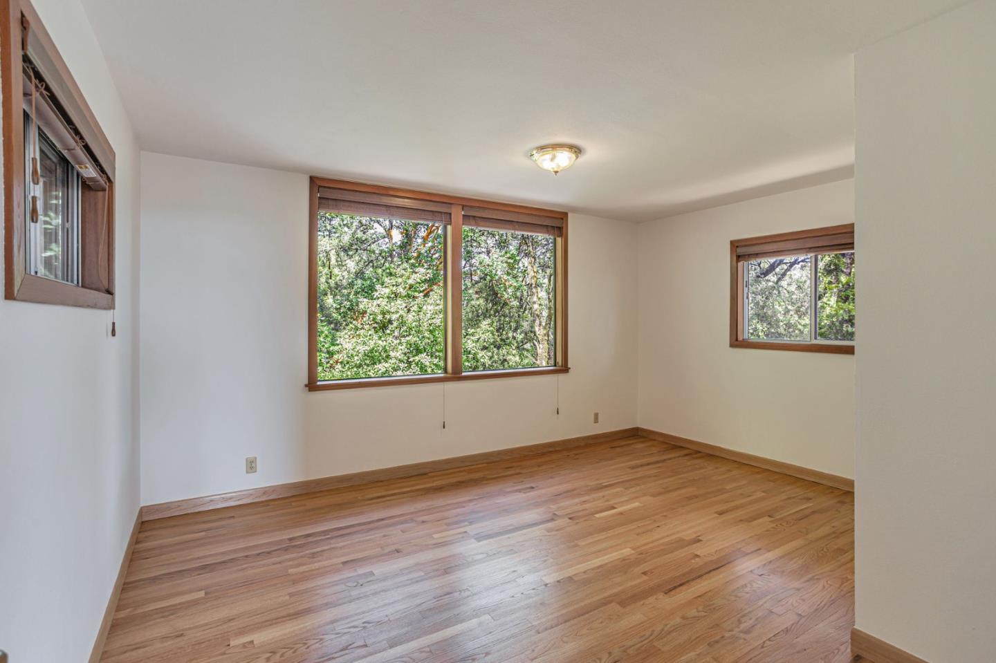 22178 Miller Ridge Road Los Gatos, CA 95033 - Photo 15 of 33 a view of an empty room with wooden floor and a window