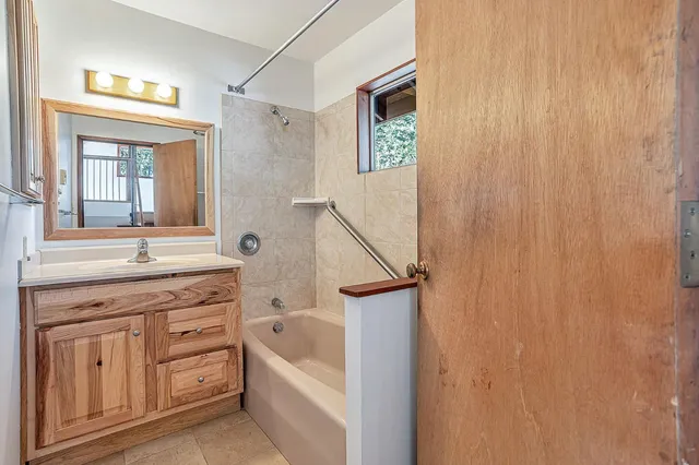 a bathroom with a tub and sink