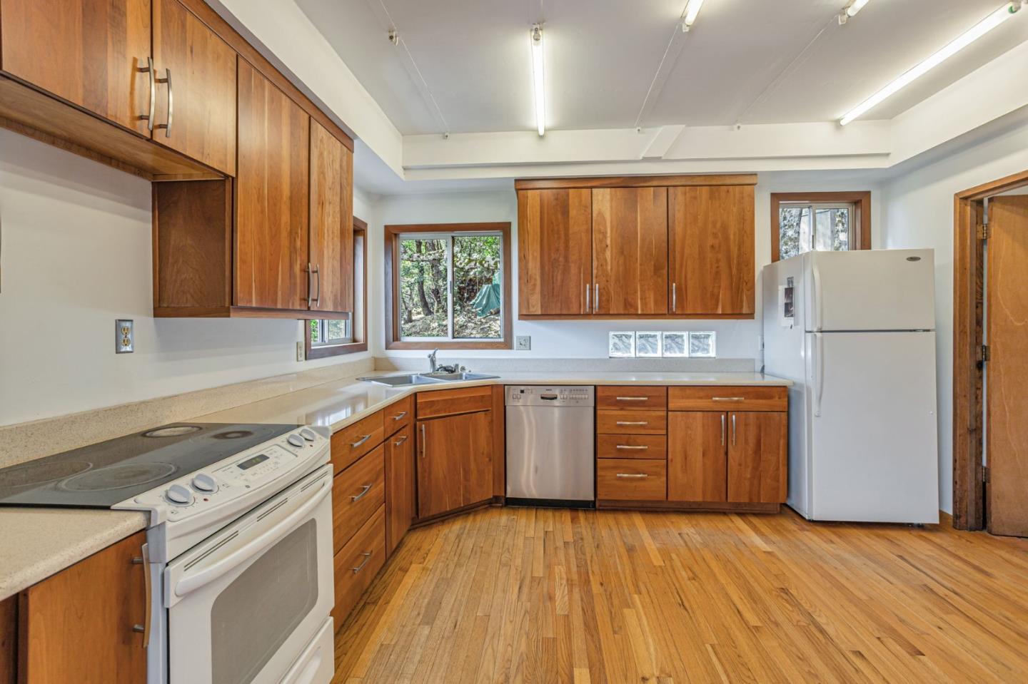 22178 Miller Ridge Road Los Gatos, CA 95033 - Photo 7 of 33 a kitchen with a refrigerator sink and cabinets