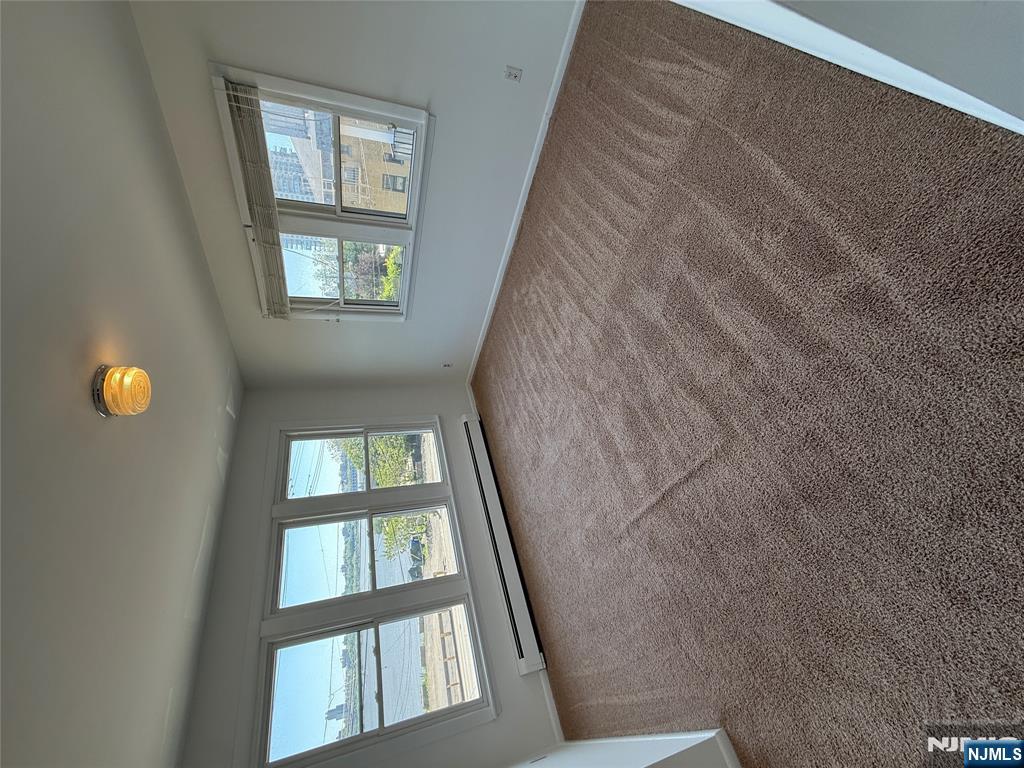 1276 River Road, Unit 2 Edgewater, NJ 07020 - Photo 4 of 16 a view of an empty room with windows