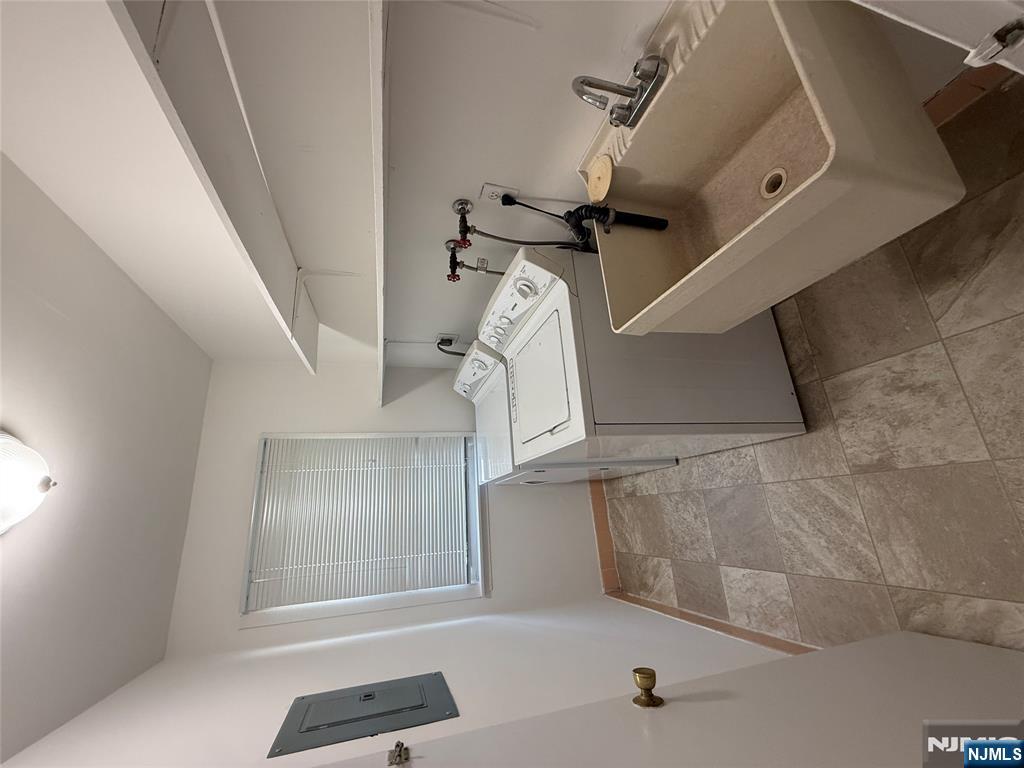 1276 River Road, Unit 2 Edgewater, NJ 07020 - Photo 9 of 16 a bathroom with a sink and mirror
