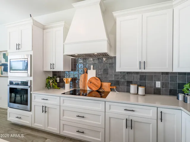 a kitchen with stainless steel appliances white cabinets and a stove
