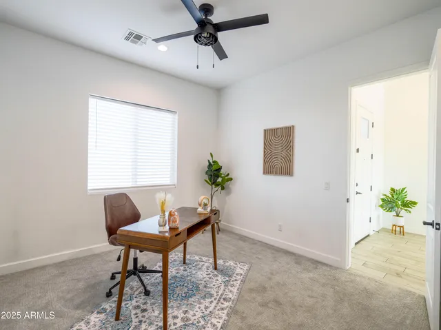 a workspace with furniture and a potted plant