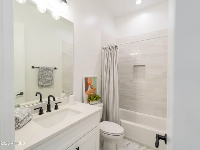 a bathroom with a sink mirror toilet and bathtub