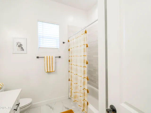 a bathroom with a shower curtain