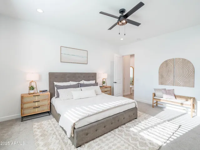 a bedroom with bed and a chandelier