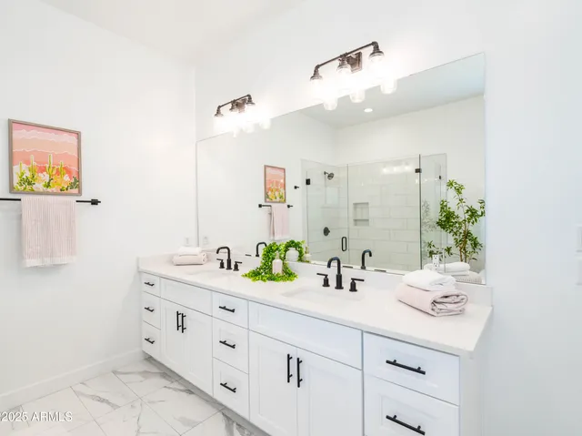 a bathroom with a double vanity sink mirror and double