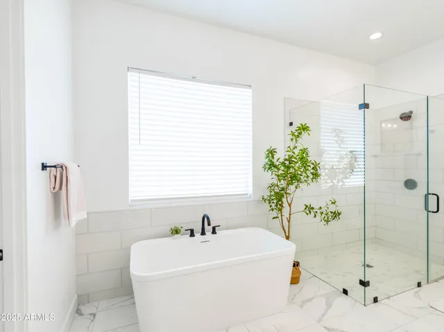 a white bath tub sitting next to a white sink